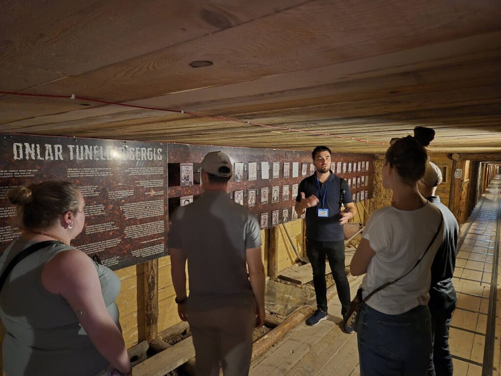 Guests inside the Tunnel of Hope war museum in Sarajevo